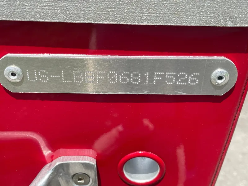 Slide: The Image of 2026 Lund SSV-16 boat identification plate on red surface. - 6