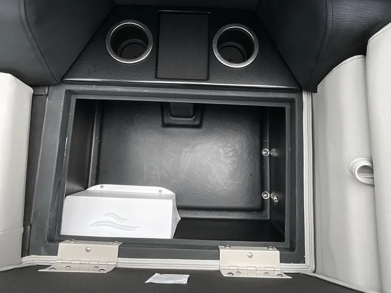 Slide: The Image of 2025 South Bay 222RSLE storage compartment with cup holders and sleek design. - 11