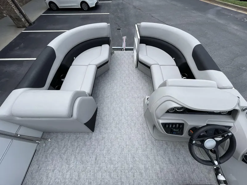 Slide: The Image of 2025 South Bay 222RSLE pontoon boat interior with plush seating and modern dashboard. - 13