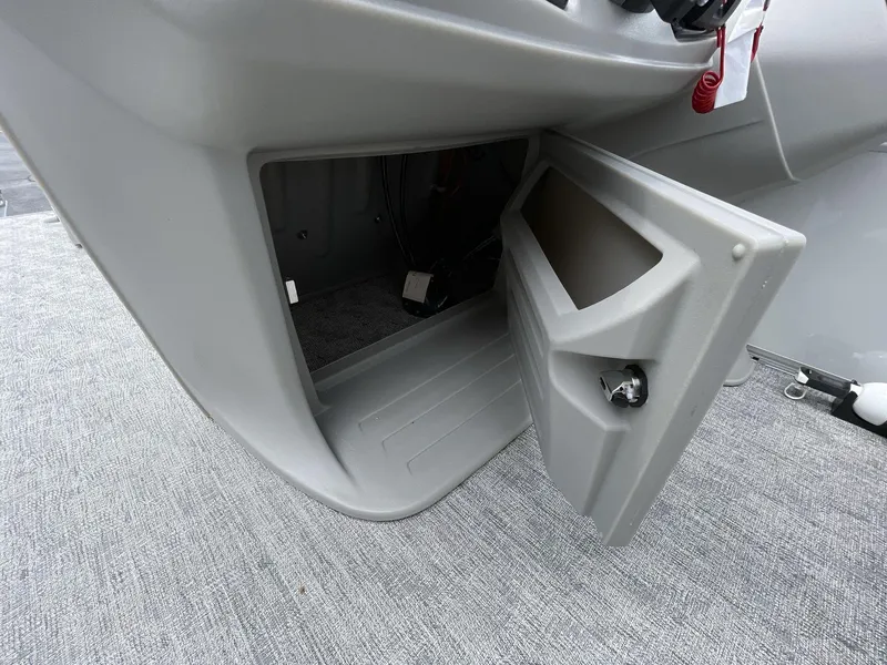Slide: The Image of Open storage compartment in 2025 South Bay 222RSLE boat console. - 14