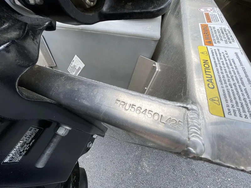 Slide: The Image of 2025 South Bay 222RSLE boat component with caution labels and serial number. - 15