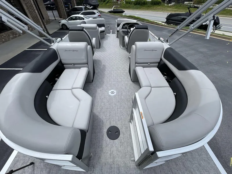 Slide: The Image of 2025 South Bay 222RSLE pontoon boat interior with gray seating and modern design. - 16