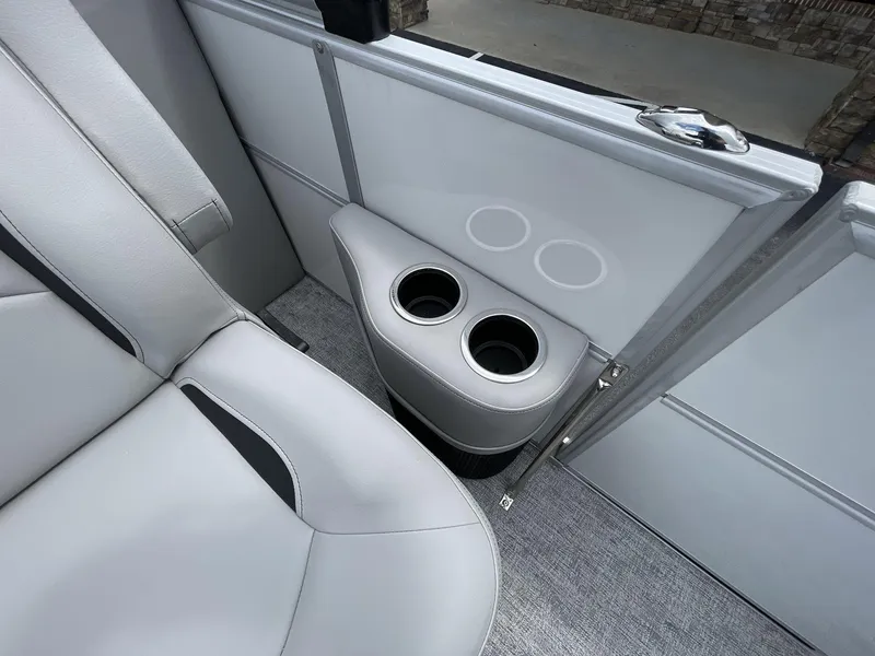 Slide: The Image of 2025 South Bay 222RSLE boat interior with cup holders and gray seating. - 17