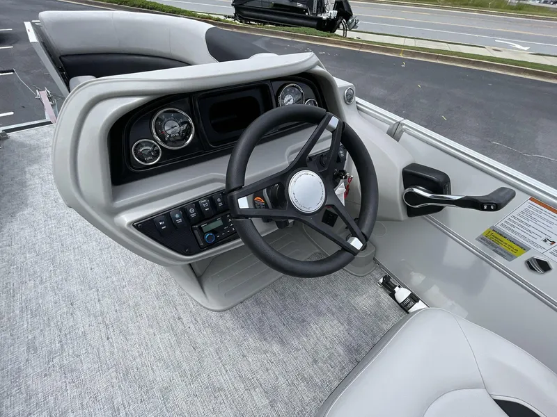 Slide: The Image of 2025 South Bay 222RSLE boat dashboard with steering wheel and control panel. - 19