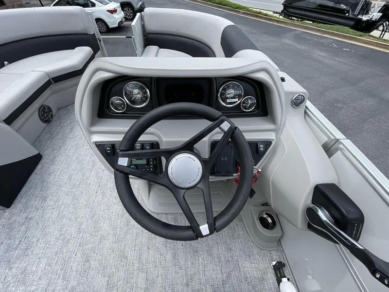 Slide: The Image of 2025 South Bay 222RSLE boat dashboard with steering wheel and gauges. - 21