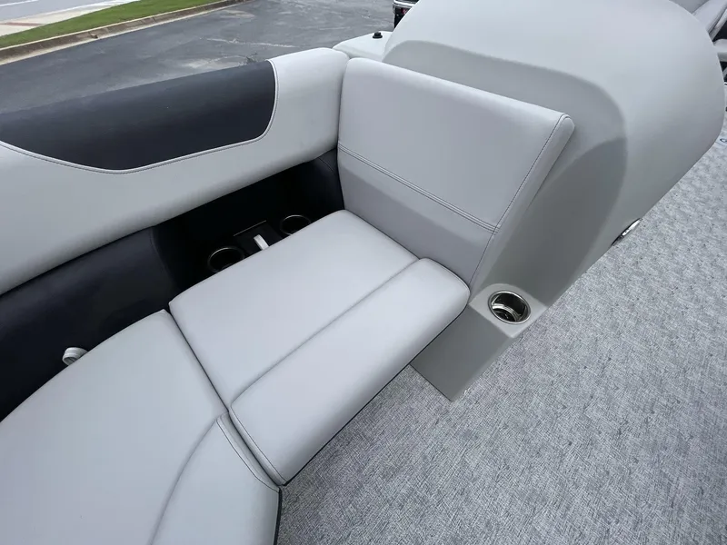 Slide: The Image of 2025 South Bay 222RSLE boat interior with gray seating and cup holders. - 26
