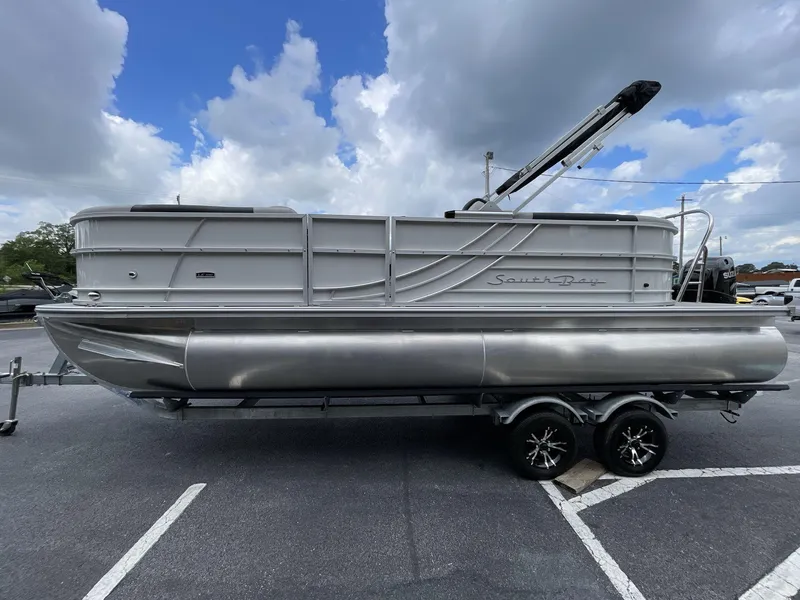 Slide: The Image of 2025 South Bay 222RSLE pontoon boat on trailer under cloudy sky. - 3