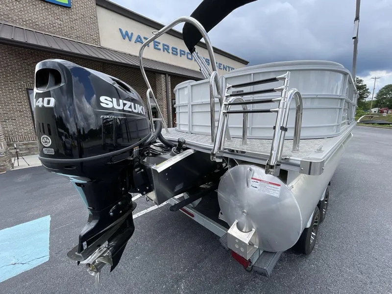 Slide: The Image of 2025 South Bay 222RSLE pontoon boat with Suzuki 140 outboard motor at watersports center. - 6