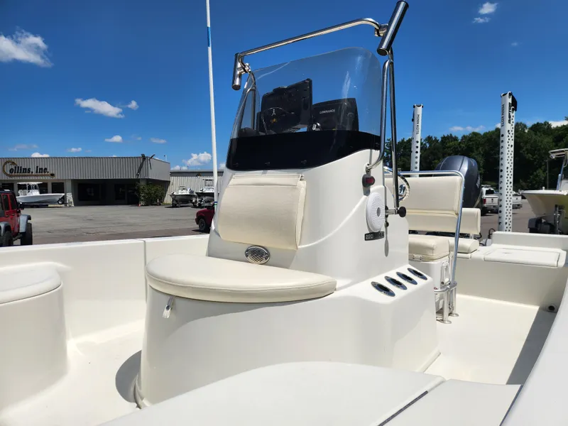 Slide: The Image of 2011 Ranger 220 Bahia boat with center console, displayed outdoors under a clear blue sky. - 10
