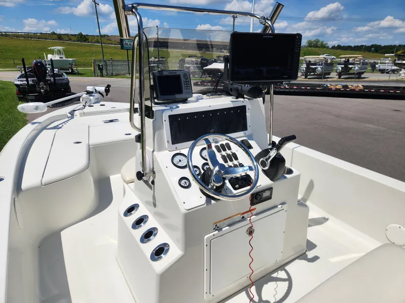 Slide: The Image of 2011 Ranger 220 Bahia boat dashboard with steering wheel and navigation equipment. - 11