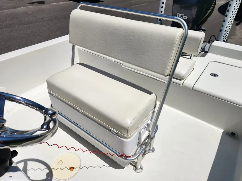 Slide: The Image of 2011 Ranger 220 Bahia boat interior with cushioned seating and steering wheel. - 13