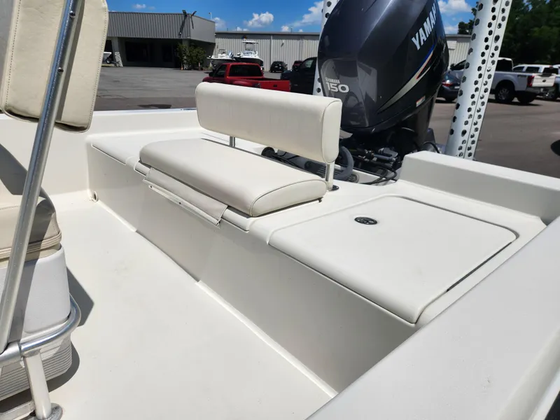 Slide: The Image of 2011 Ranger 220 Bahia boat with Yamaha 150 engine, featuring white seating and storage. - 14