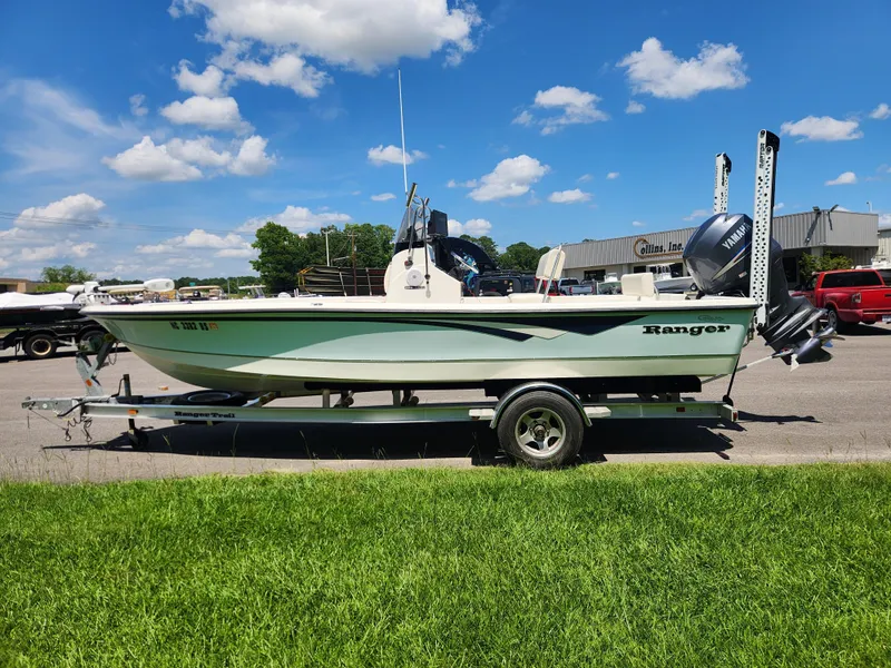 Slide: The Image of 2011 Ranger 220 Bahia boat on trailer under a clear blue sky. - 5