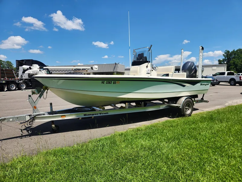Slide: The Image of 2011 Ranger 220 Bahia boat on trailer under clear blue sky. - 6