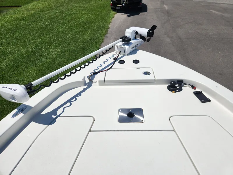 Slide: The Image of 2011 Ranger 220 Bahia boat deck with trolling motor, parked on grass and pavement. - 8