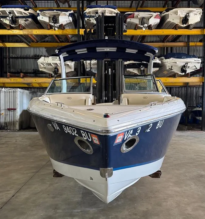 Slide: The Image of 2014 Cobalt R5 boat in storage, front view, surrounded by other boats. - 1