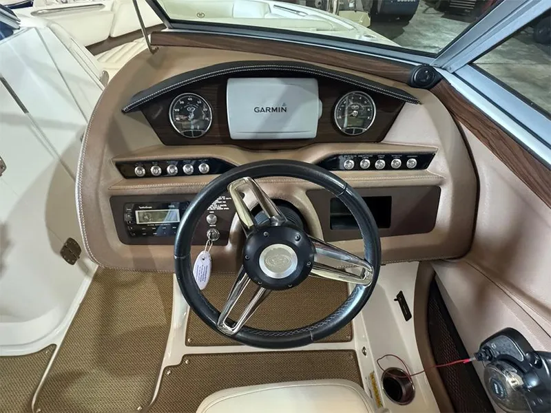 Slide: The Image of 2014 Cobalt R5 boat dashboard with Garmin display and steering wheel. - 12
