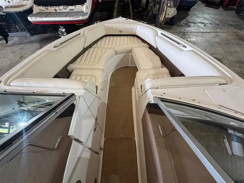 Slide: The Image of 2014 Cobalt R5 boat interior with white leather seating and carpeted flooring. - 16
