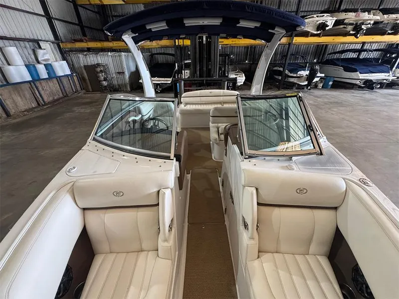 Slide: The Image of 2014 Cobalt R5 boat interior with white leather seats in a storage facility. - 19