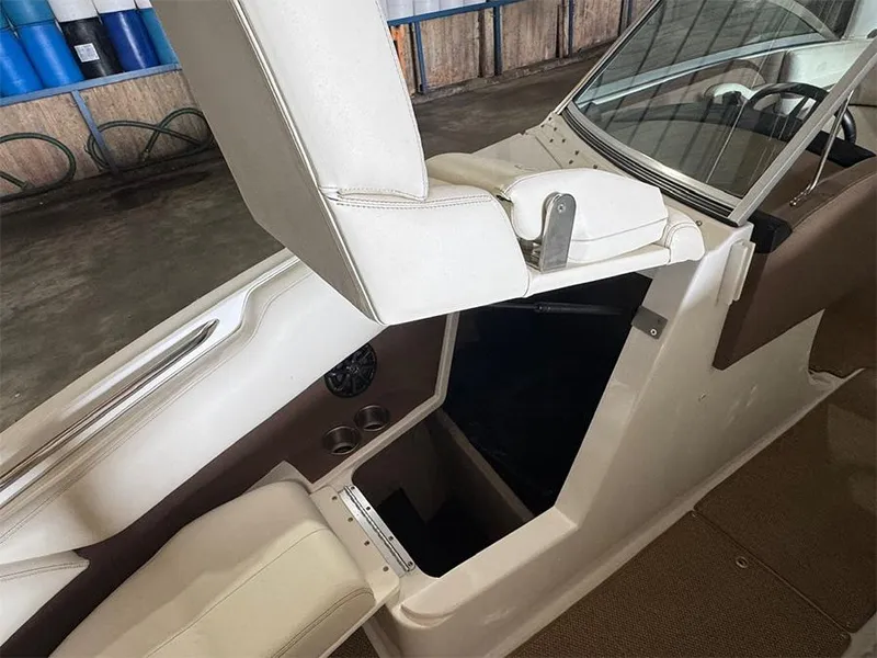 Slide: The Image of 2014 Cobalt R5 boat interior with white seating and storage compartment. - 21