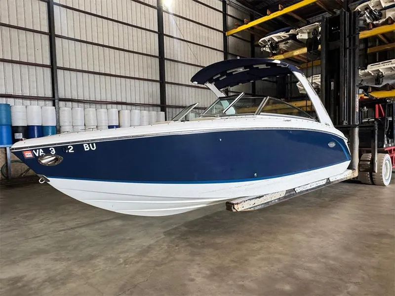 Slide: The Image of 2014 Cobalt R5 boat in storage, blue and white hull, indoor facility. - 4