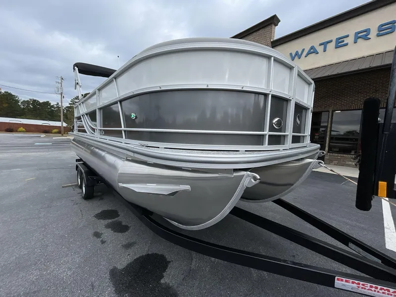 Slide: The Image of 2025 South Bay 222 RSLE pontoon boat on trailer, parked outside dealership. - 10