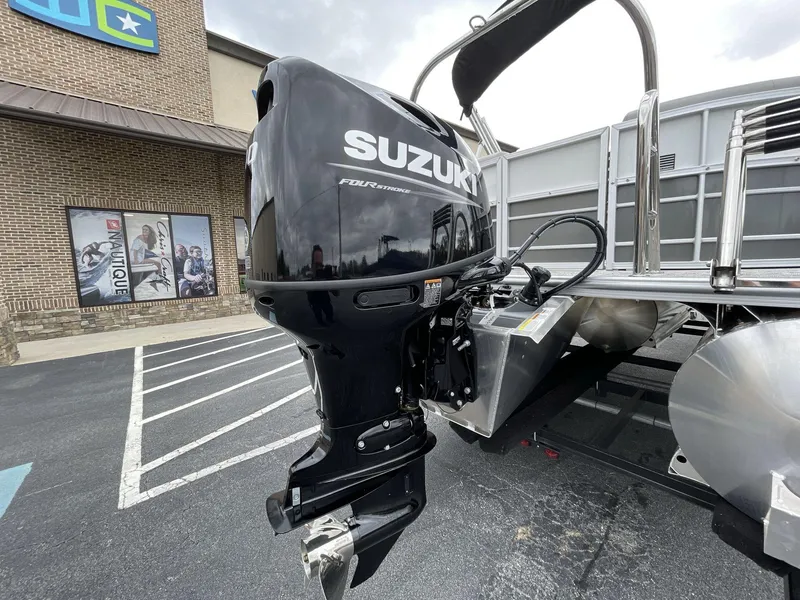 Slide: The Image of 2025 South Bay 222 RSLE with Suzuki outboard motor in parking lot. - 13