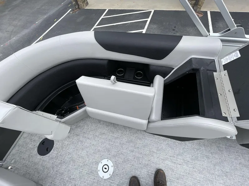 Slide: The Image of 2025 South Bay 222 RSLE boat interior with open storage compartments and seating. - 17
