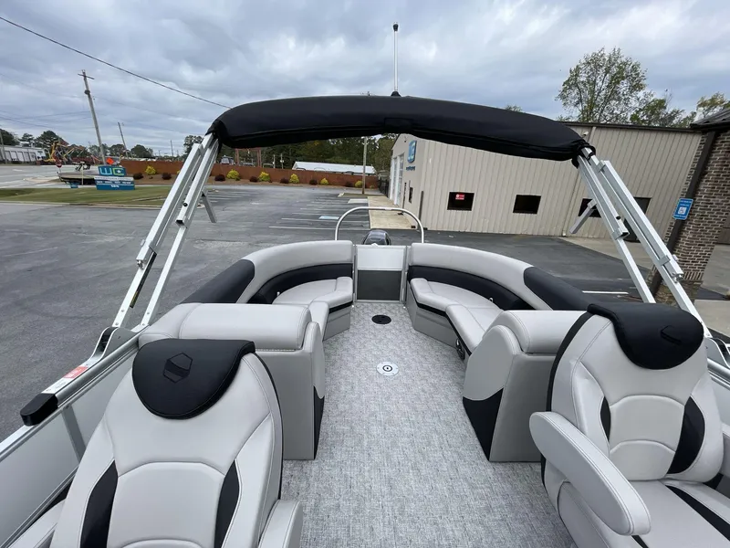 Slide: The Image of 2025 South Bay 222 RSLE pontoon boat with sleek seating and canopy in a parking lot. - 18