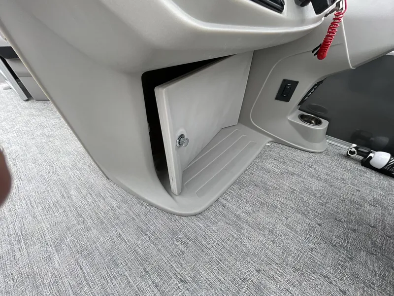 Slide: The Image of Interior of 2025 South Bay 222 RSLE boat showing storage compartment and carpeted flooring. - 19