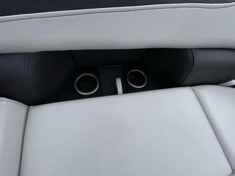 Slide: The Image of 2025 South Bay 222 RSLE interior with cup holders and light gray seating. - 21