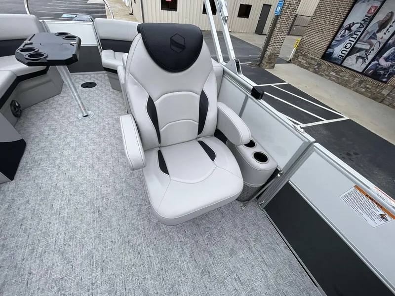 Slide: The Image of Captain's chair on 2025 South Bay 222 RSLE pontoon boat, featuring cup holders and sleek design. - 22