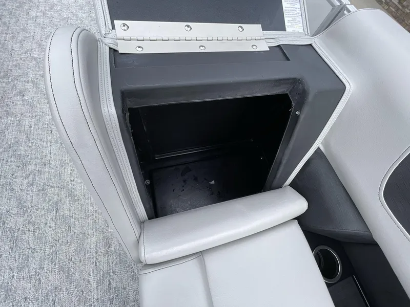 Slide: The Image of Open storage compartment in 2025 South Bay 222 RSLE boat seat. - 23