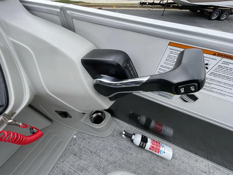 Slide: The Image of Throttle control of 2025 South Bay 222 RSLE boat with safety features and fire extinguisher. - 25