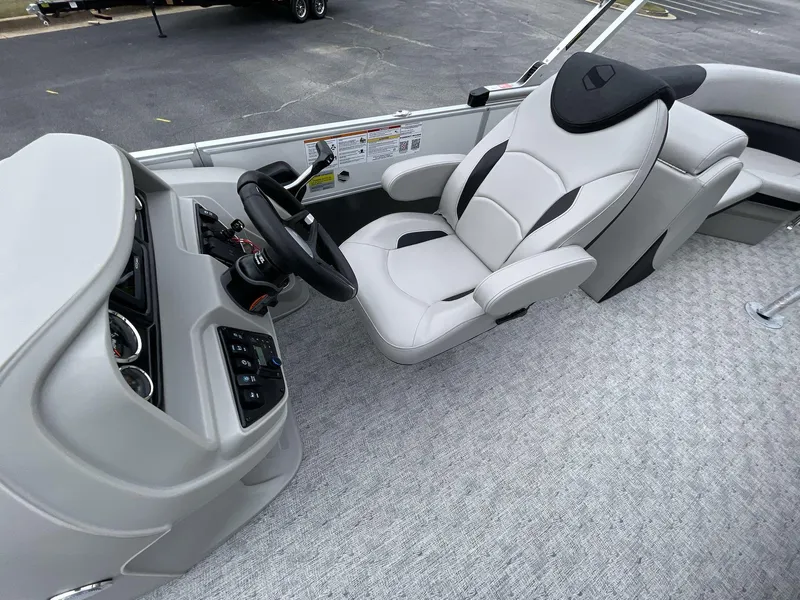 Slide: The Image of Captain's seat and helm of 2025 South Bay 222 RSLE boat, featuring modern controls. - 27