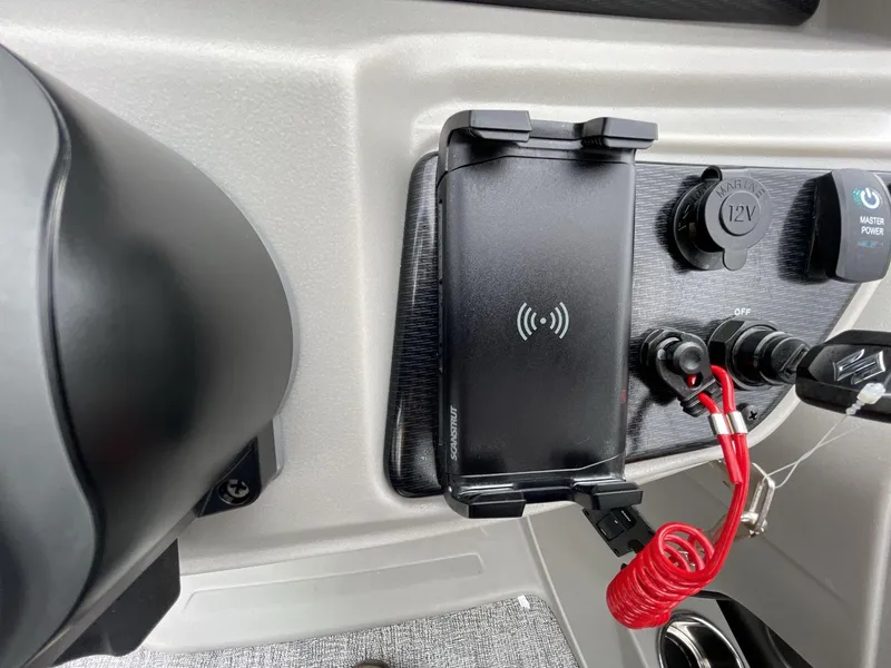 Slide: The Image of Control panel of 2025 South Bay 222 RSLE with wireless charger and power switches. - 28