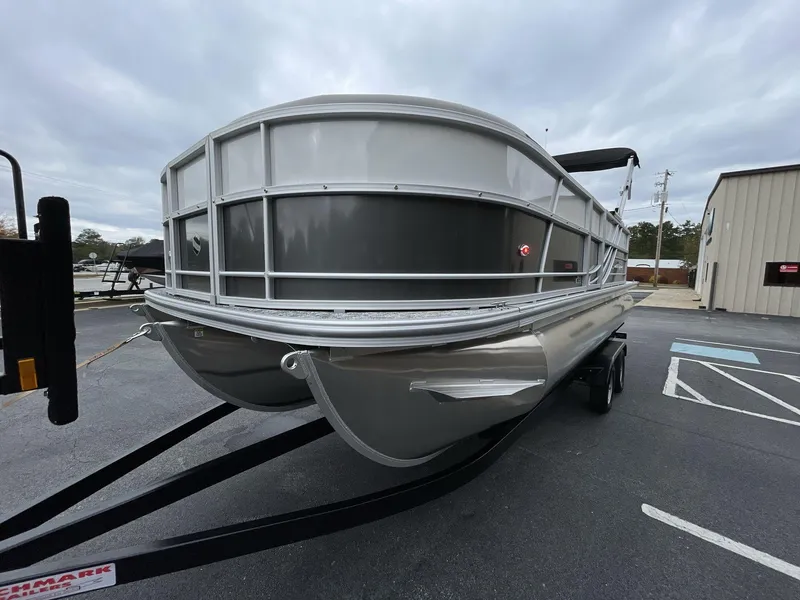 Slide: The Image of 2025 South Bay 222 RSLE pontoon boat on trailer, parked outdoors. - 3