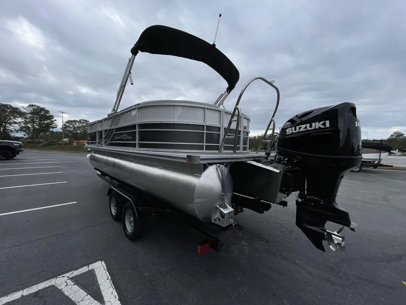 Slide: The Image of 2025 South Bay 222 RSLE pontoon boat with Suzuki outboard motor in parking lot. - 5