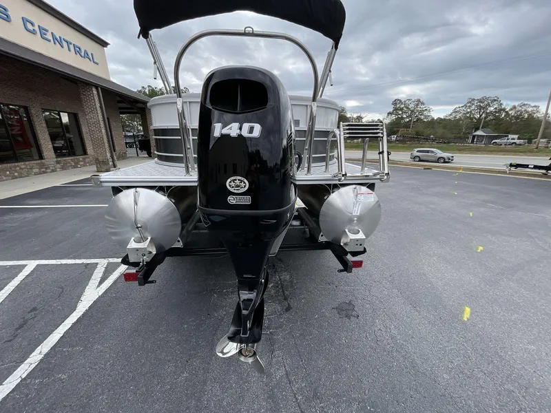 Slide: The Image of 2025 South Bay 222 RSLE pontoon boat with 140 HP engine, parked outdoors. - 6