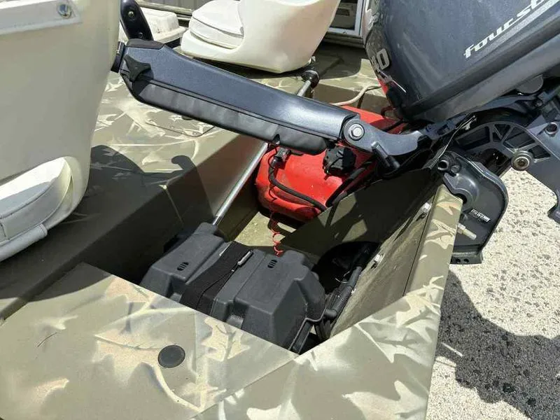 Slide: The Image of 2023 Tracker Grizzly 1648 Jon boat with motor and battery compartment. - 11