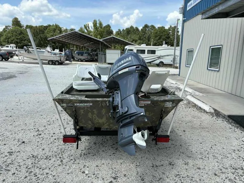 Slide: The Image of 2023 Tracker Grizzly 1648 Jon boat with Yamaha outboard motor, parked outdoors. - 3