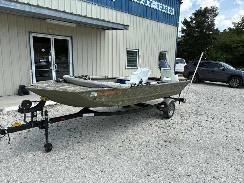 Slide: The Image of 2023 Tracker Grizzly 1648 Jon boat on trailer outside a building. - 4