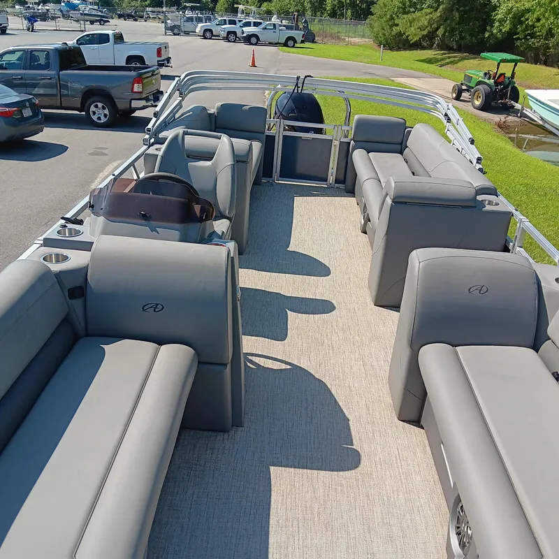 Slide: The Image of 2022 Avalon VLS Quad Lounge pontoon boat with spacious seating and modern design. - 5