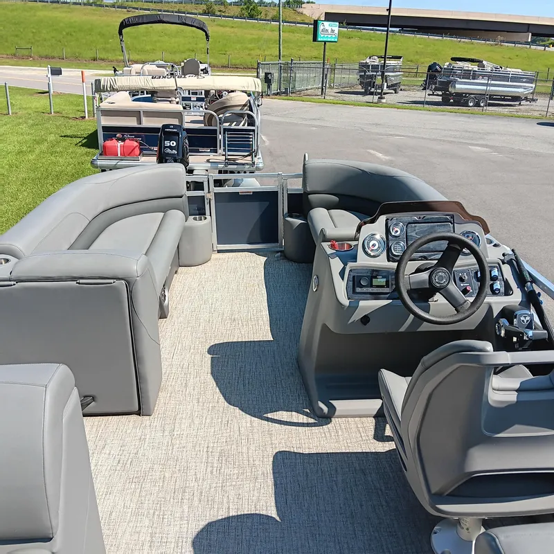 Slide: The Image of 2022 Avalon VLS Quad Lounge pontoon boat with modern seating and steering console. - 8
