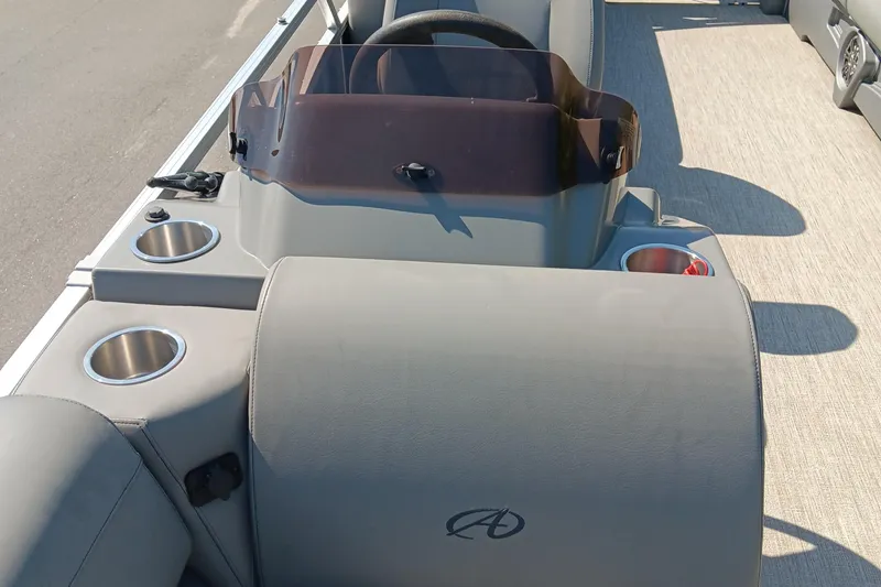 Slide: The Image of 2022 Avalon VLS Quad Lounge interior with cup holders and steering console. - 9