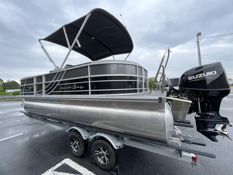 Slide: The Image of 2025 South Bay 222RSLE pontoon boat with Suzuki outboard motor on trailer. - 11