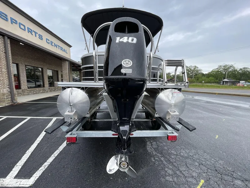 Slide: The Image of 2025 South Bay 222RSLE pontoon boat with 140 HP engine at dealership parking lot. - 12