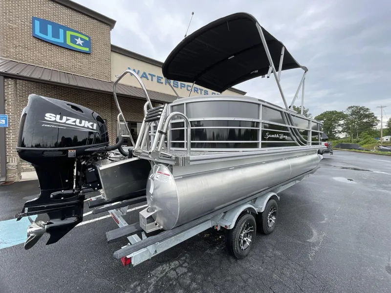 Slide: The Image of 2025 South Bay 222RSLE pontoon boat with Suzuki engine at watersports dealership. - 13