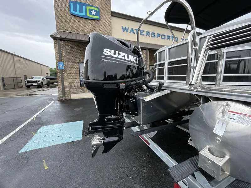 Slide: The Image of 2025 South Bay 222RSLE pontoon boat with Suzuki outboard motor at Watersports dealership. - 16
