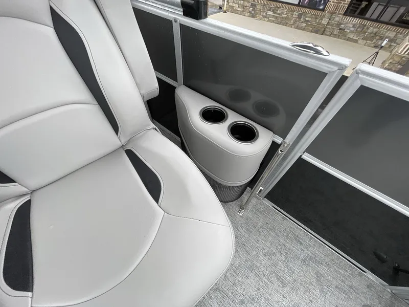Slide: The Image of 2025 South Bay 222RSLE boat interior with gray seating and dual cup holders. - 21